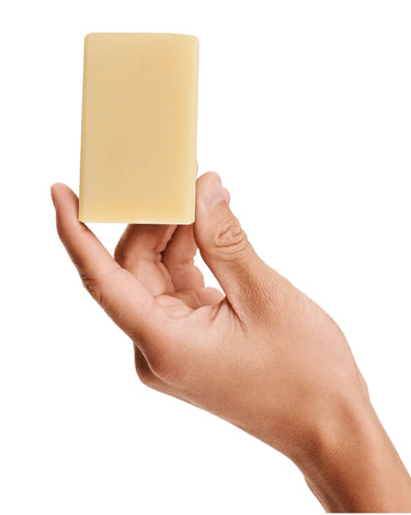Image of a model holding Antü Refreshing bar of soap.
