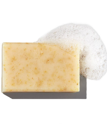 Bia unscented soap with soap bubbles on a white background.