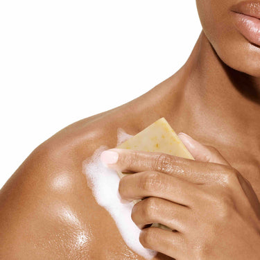Image of a model rubbing her skin with the Bia Unscented Soap