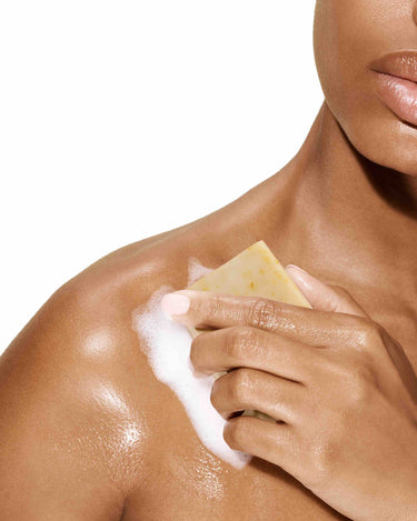 Image of a model rubbing her skin with the Bia Unscented Soap